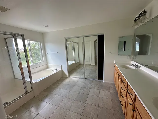 a spacious bathroom with a tub and sink