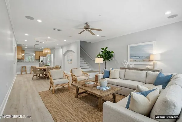 a living room with furniture wooden floor and a chandelier