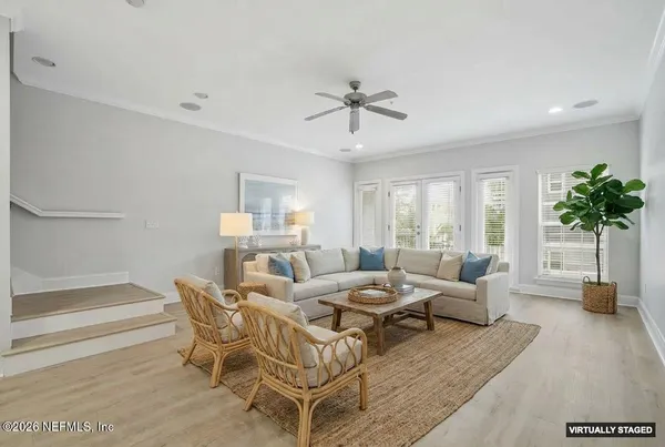 a living room with furniture and a potted plant