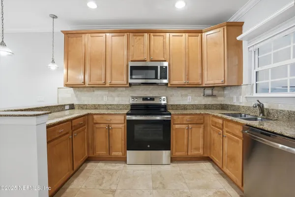a kitchen with a sink stove and microwave