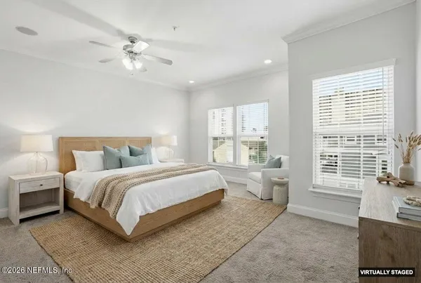 a spacious bedroom with a bed and a chandelier