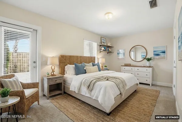 a bed room with a bed and a chair