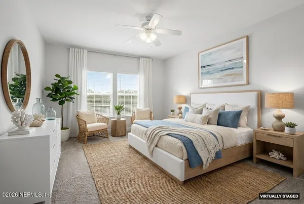 a bedroom with bed and a large window