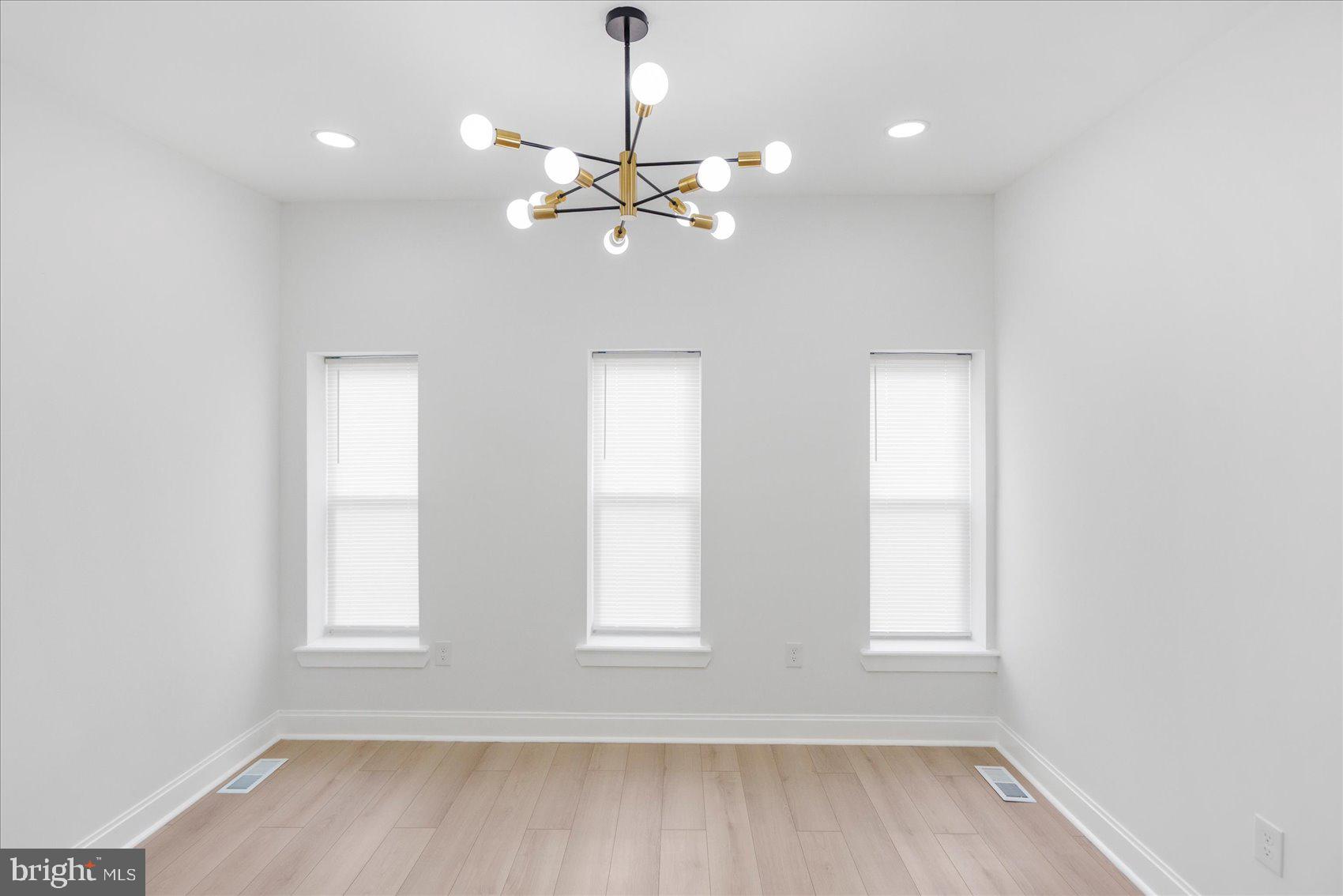 2424 East Biddle Street Baltimore, MD 21213 - Photo 12 of 27 a view of an empty room with wooden floor and a window