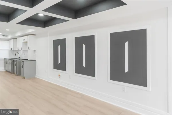 a view of a hallway with wooden cabinets