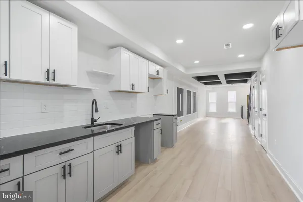 a kitchen with a sink and cabinets