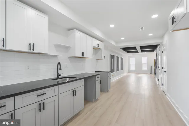 a kitchen with a sink and cabinets