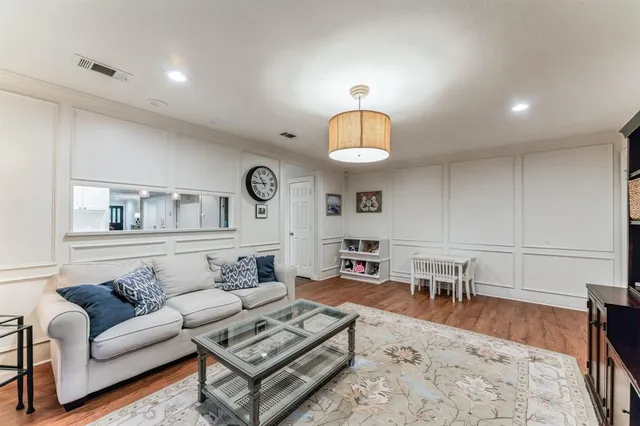 a living room with furniture a chandelier and a table