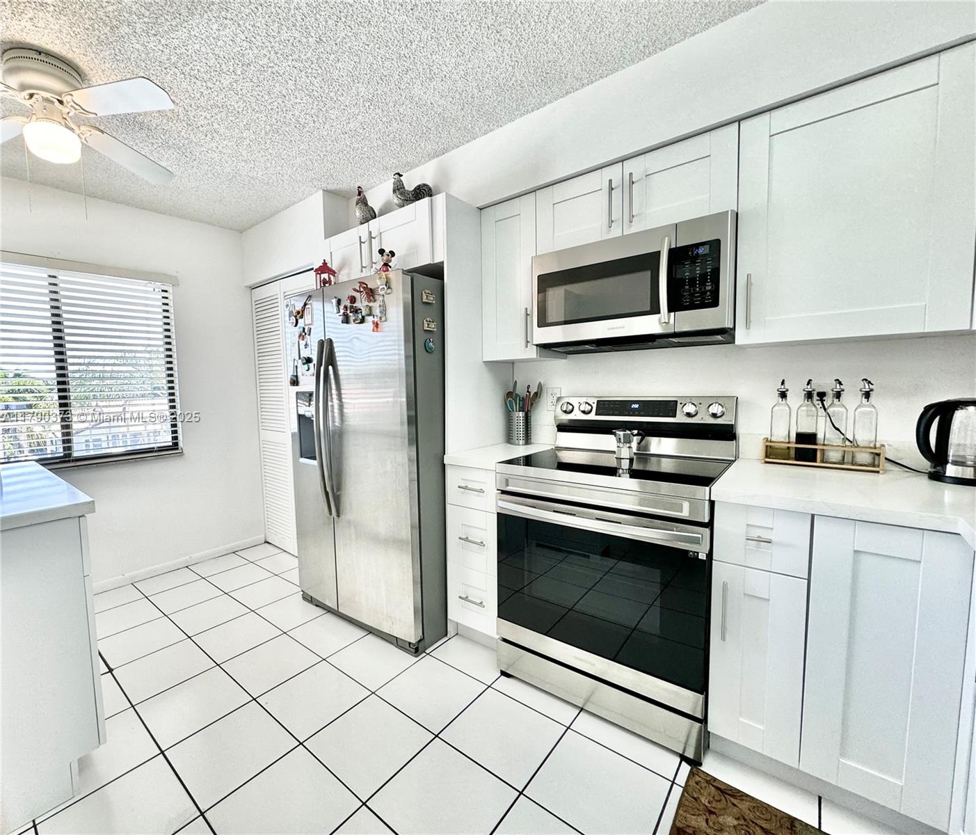 a kitchen with stainless steel appliances granite countertop a refrigerator microwave and sink