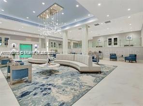 6193 Pointe Regal Circle, Unit 304 Delray Beach, FL 33484 - Photo 12 of 15 a living room with furniture and a chandelier