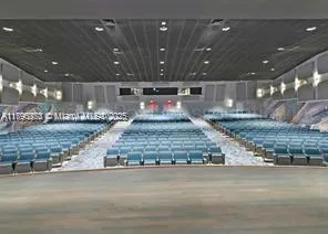 a large room with a kitchen island a large island in the center