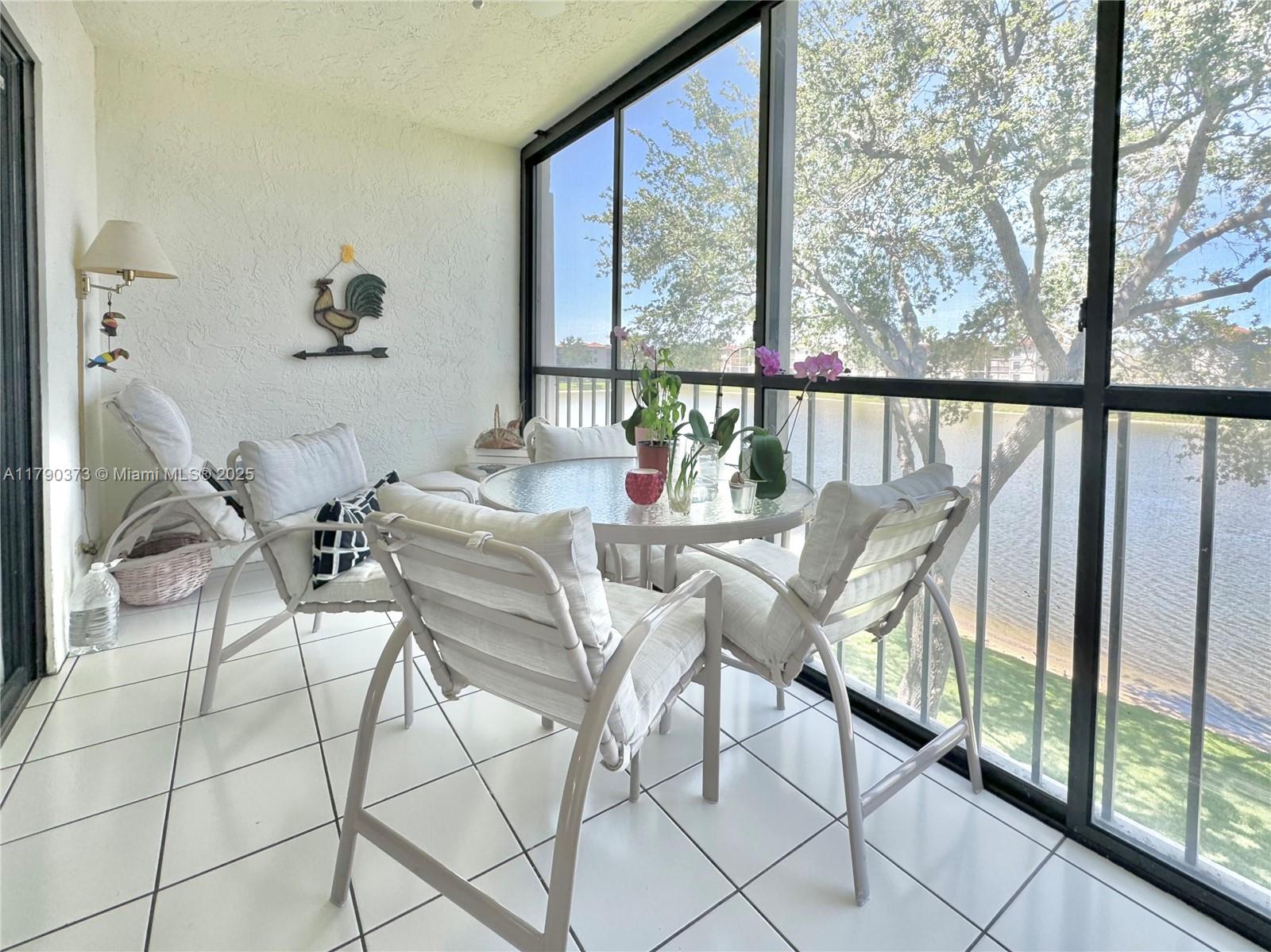 6193 Pointe Regal Circle, Unit 304 Delray Beach, FL 33484 - Photo 3 of 15 a dining room with furniture and large windows