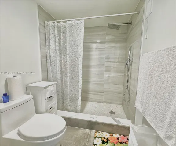 a bathroom with a shower and a toilet