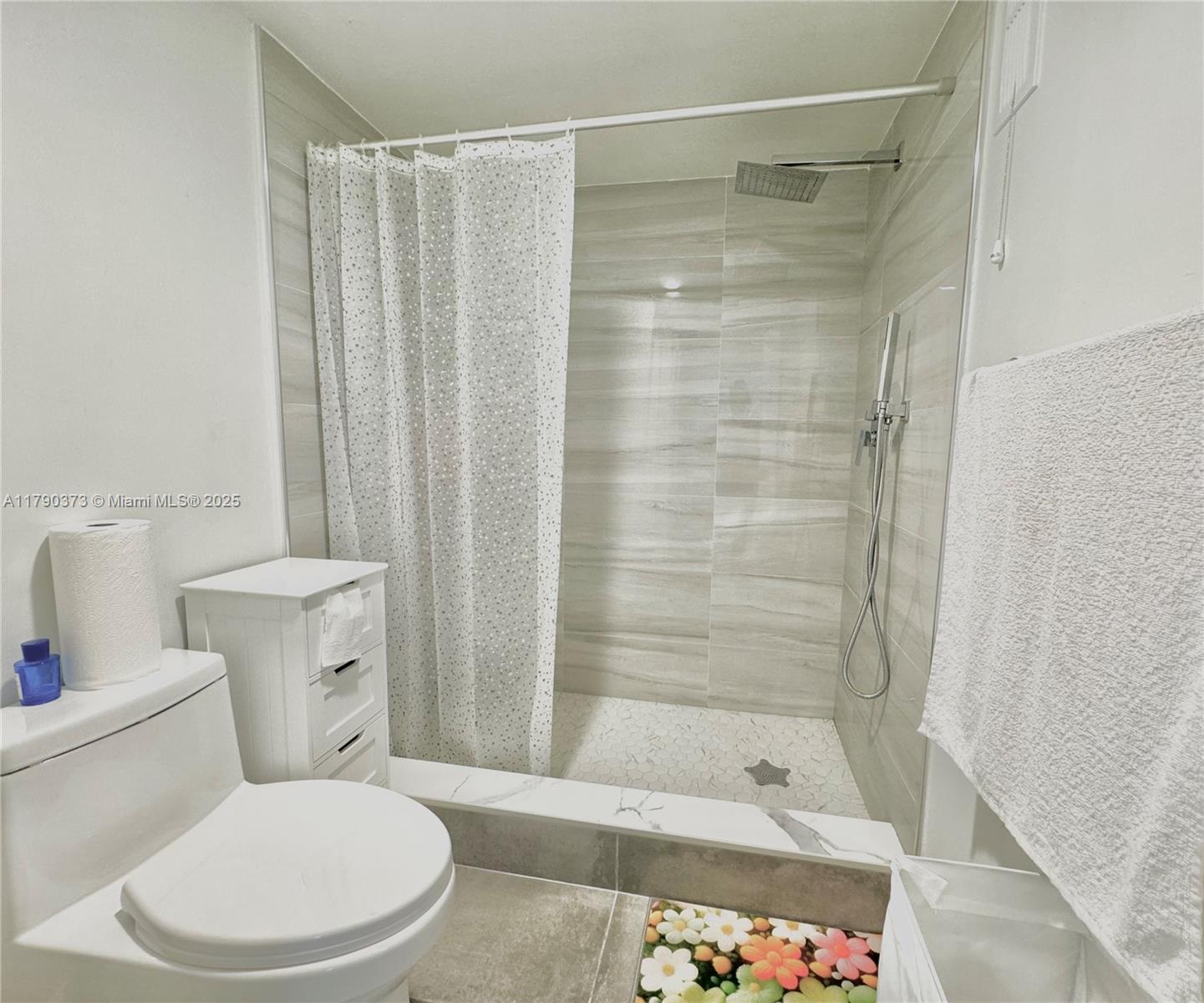 6193 Pointe Regal Circle, Unit 304 Delray Beach, FL 33484 - Photo 7 of 15 a bathroom with a shower and a toilet
