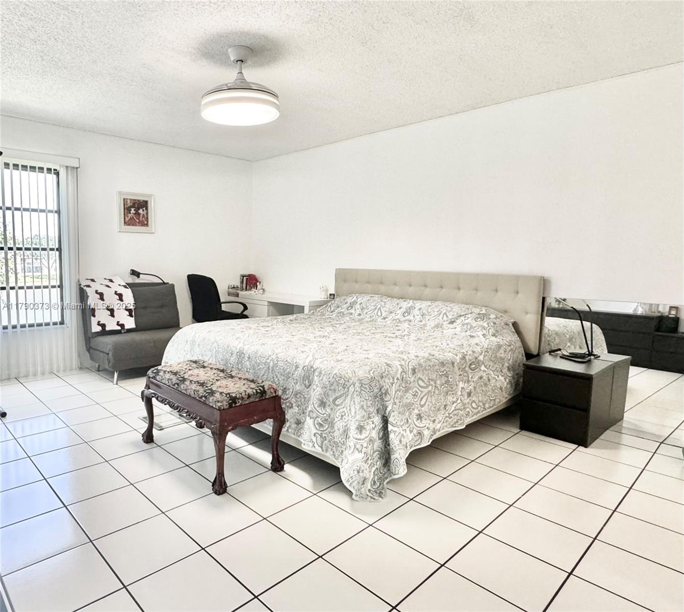6193 Pointe Regal Circle, Unit 304 Delray Beach, FL 33484 - Photo 8 of 15 a bedroom with a bed and a table chair