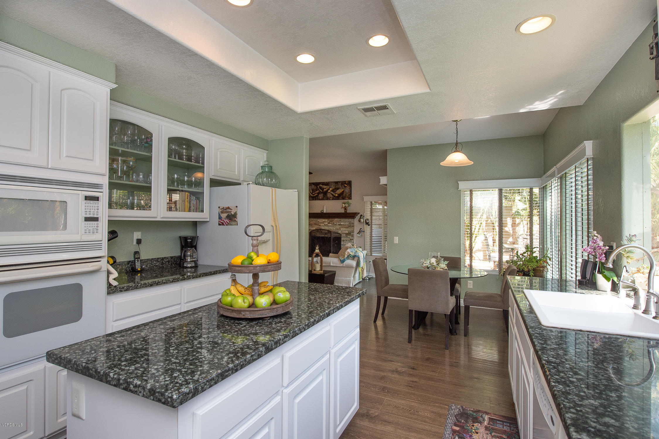 7354 Griffith Lane Moorpark, CA 93021 - Photo 18 of 53 a kitchen with stainless steel appliances granite countertop wooden cabinets a stove top oven a sink and dishwasher