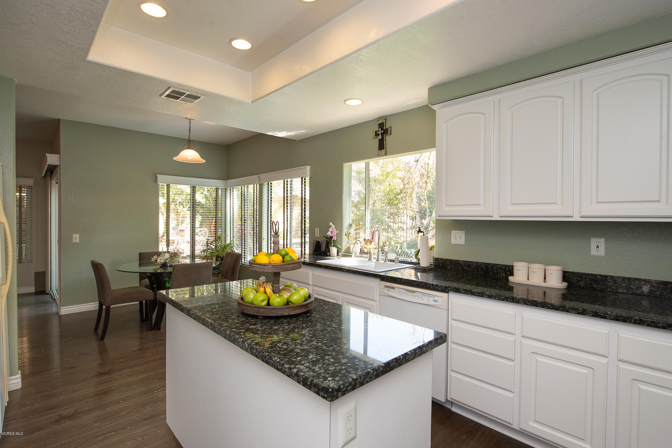 7354 Griffith Lane Moorpark, CA 93021 - Photo 19 of 53 a kitchen with sink cabinets and dining table