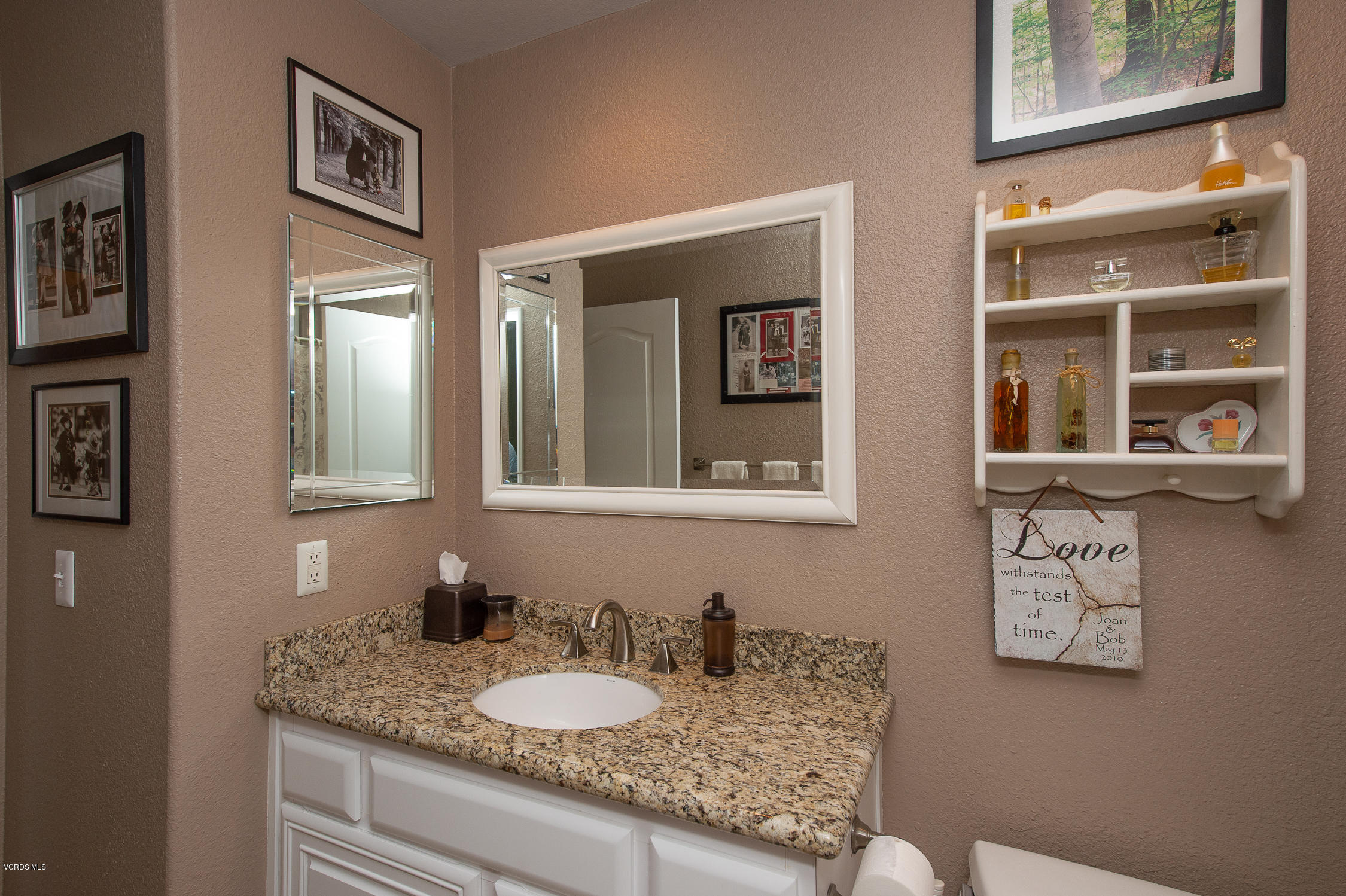 7354 Griffith Lane Moorpark, CA 93021 - Photo 21 of 53 a bathroom with a granite countertop sink and a mirror