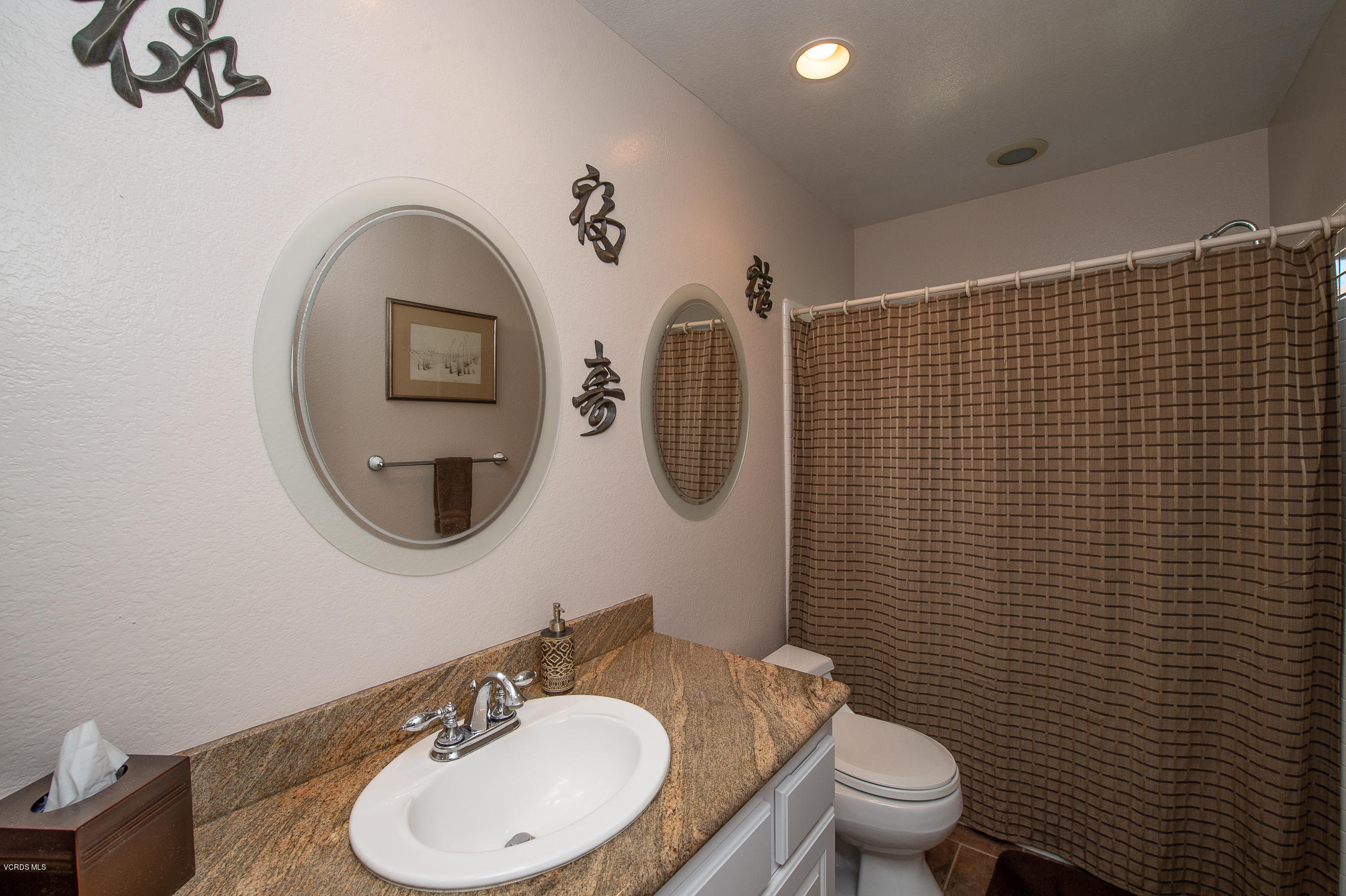 7354 Griffith Lane Moorpark, CA 93021 - Photo 32 of 53 a bathroom with a toilet a sink and mirror