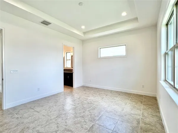an empty room with windows and closet