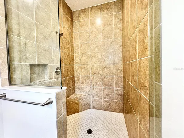 a bathroom with a shower and a sink