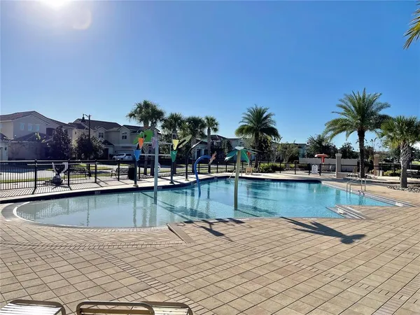 a view of a house with swimming pool and sitting area