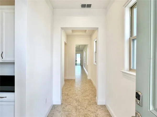 a view of a hallway with paintings on the wall