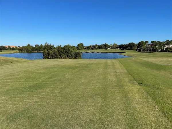 a view of a golf course with a lake view