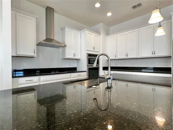 a kitchen with a sink and white cabinets