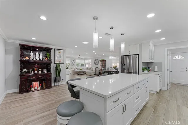 a large kitchen with stainless steel appliances lots of counter space and wooden floor