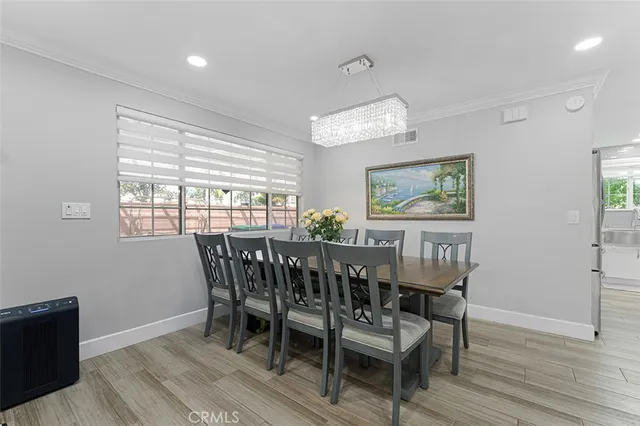 a view of a dining room with furniture wooden floor and chandelier