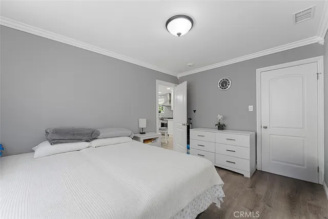 a bedroom with a bed and dresser