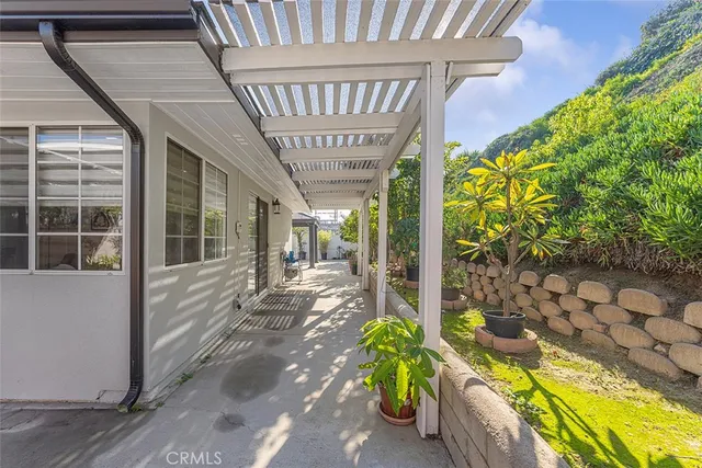 a view of a porch with chairs and plants