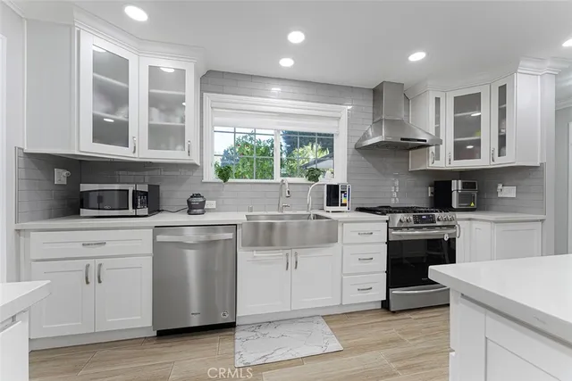 a kitchen with a stove a sink and a refrigerator