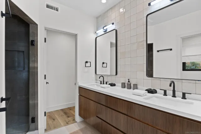 a bathroom with a double vanity sink mirror and double