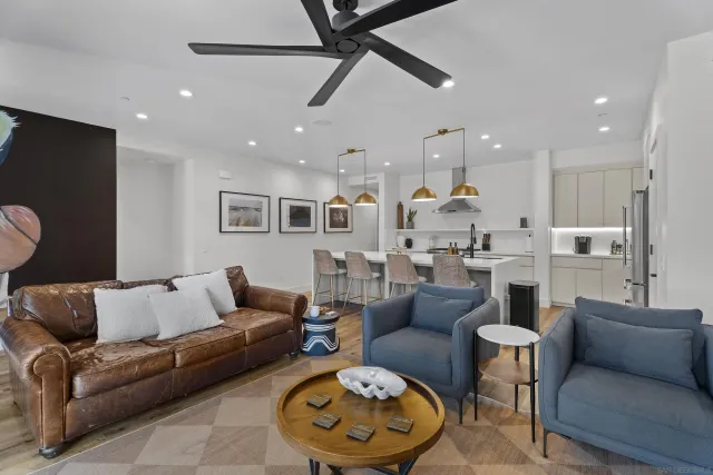 a living room with furniture and kitchen view