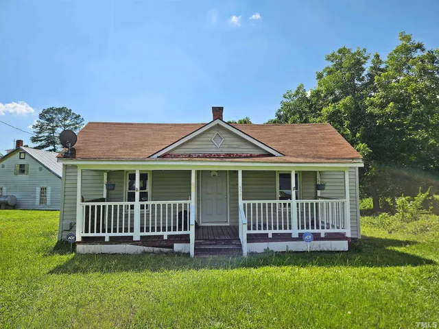 a view of a house with a yard and a deck
