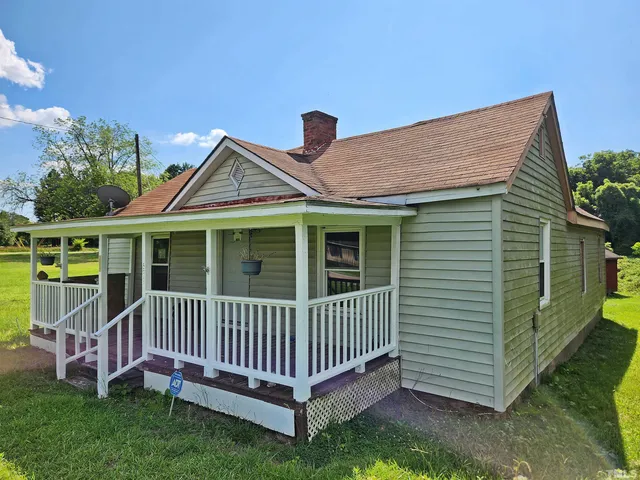 a view of a house with a yard and deck