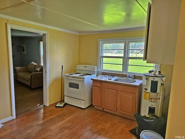a kitchen with a sink and a stove top oven
