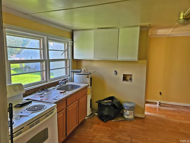a kitchen that has a stove and a wooden cabinets