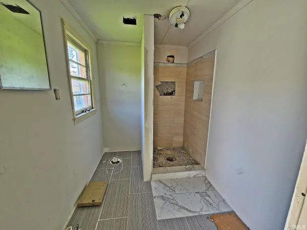 a bathroom with a sink and glass door