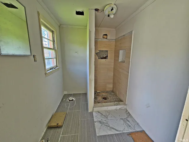 a bathroom with a sink and glass door