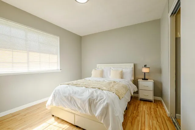 a bedroom with a bed and window