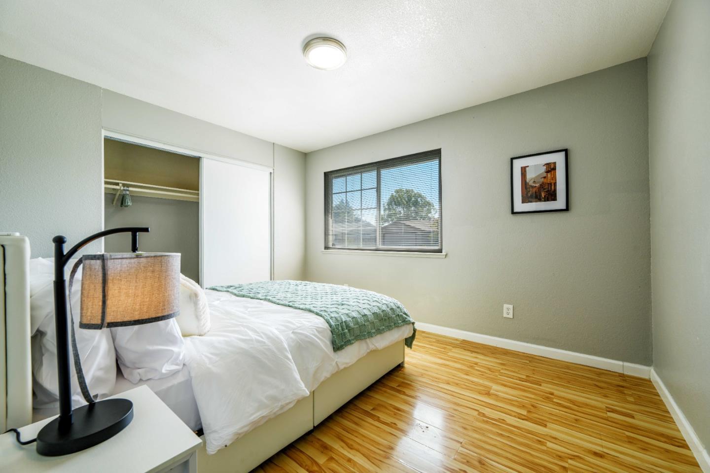 8617 Lodestone Circle Elk Grove, CA 95624 - Photo 14 of 23 a bedroom with a bed and wooden floor