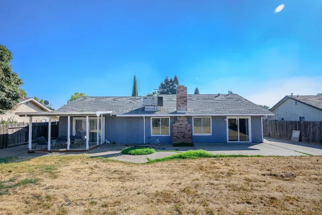 a front view of a house with a garden and yard