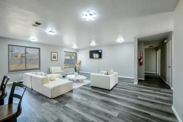 a living room with fireplace furniture and a wooden floor