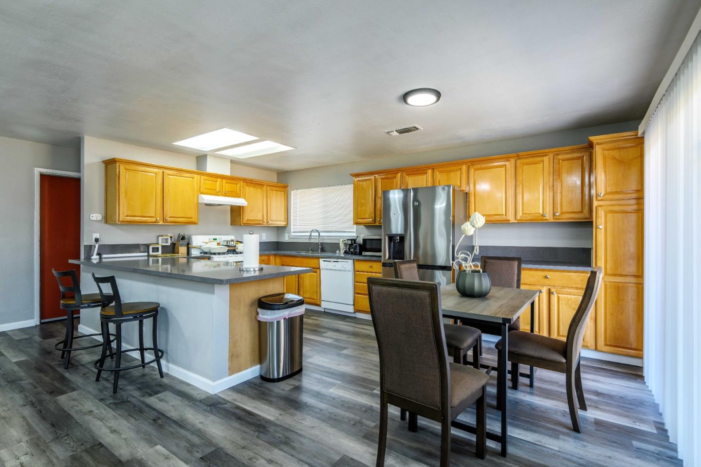 8617 Lodestone Circle Elk Grove, CA 95624 - Photo 5 of 23 a dining room with a table chairs and kitchen view