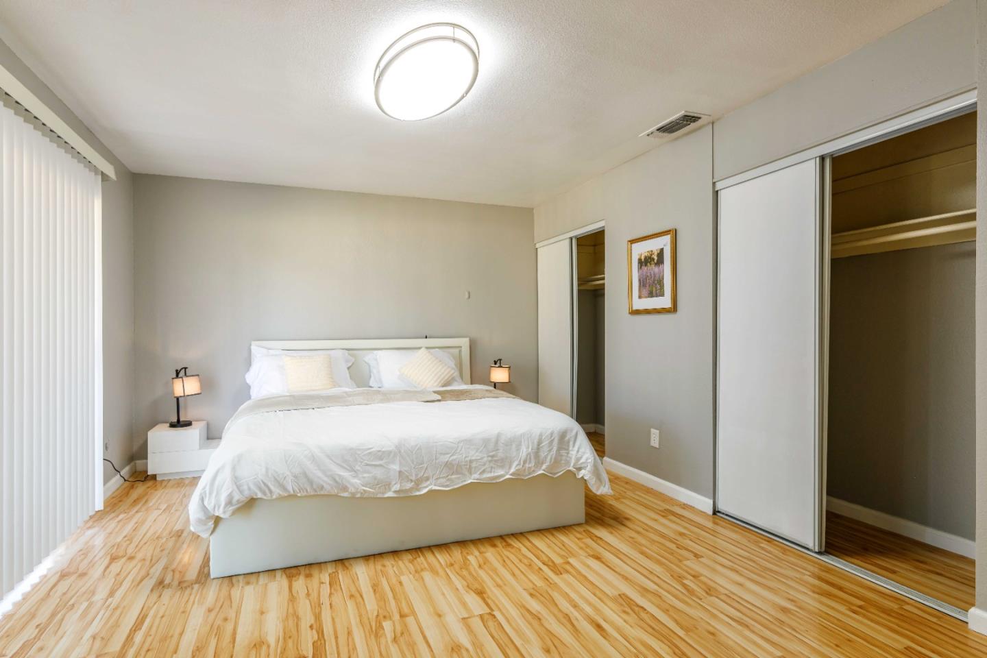 8617 Lodestone Circle Elk Grove, CA 95624 - Photo 8 of 23 a bedroom with a bed and wooden floor