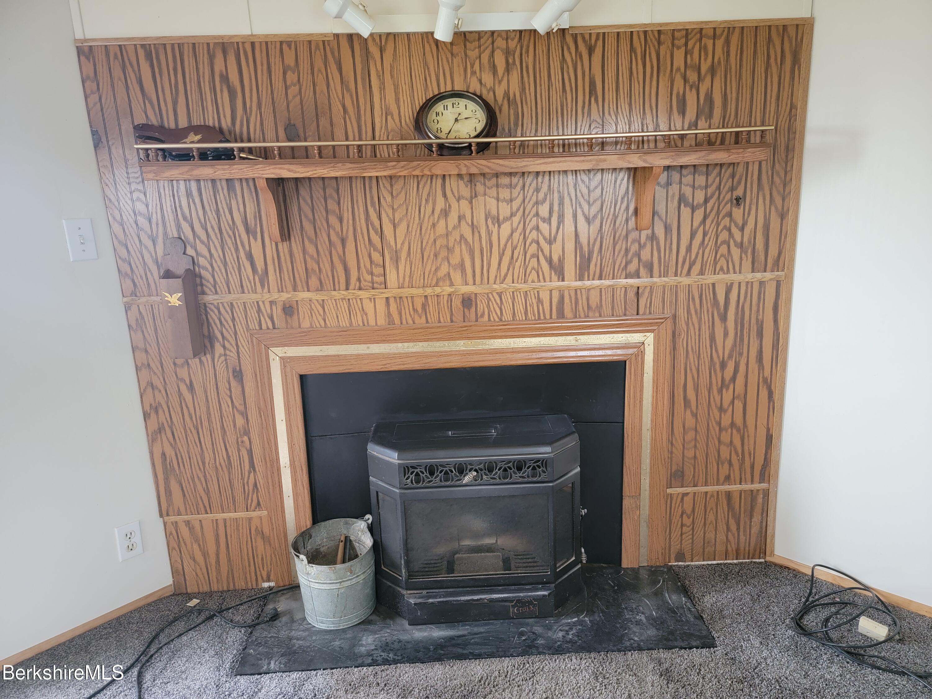 47 Moore's Road North Adams, MA 01247 - Photo 9 of 19 a close view of a fireplace with a chair and a wooden floor