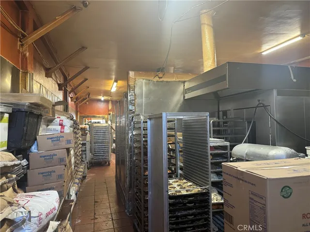 a room with lots of wooden furniture and a chandelier